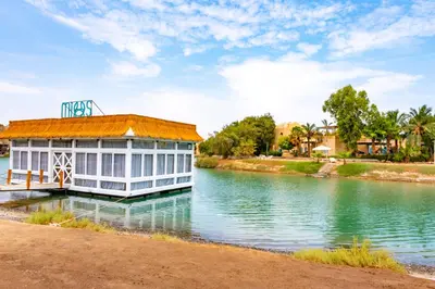 a building on the water next to a river at Studio Serenity Downtown El Gouna in Hurghada