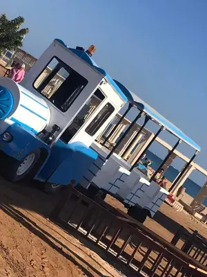 a blue and white truck parked on the beach at Hambra avenue in Hurghada