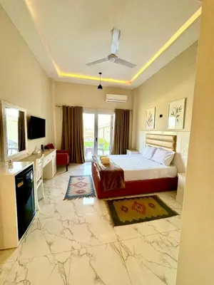 a large bedroom with a bed and a bathroom at Royal Nile Suites - Luxury Nile View 1 in Al Aqālitah