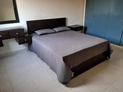 a bedroom with a large bed with two night stands at Family Fun -Spacious Apartment in Hurghada