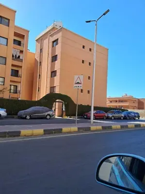 a view of a street with cars parked in a parking lot at Family Fun -Spacious Apartment in Hurghada