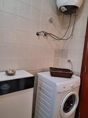 a small bathroom with a washing machine at Family Fun -Spacious Apartment in Hurghada