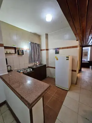 a kitchen with a refrigerator and a counter top at Desert Rose residence 1 bedroom flat in El Kawher in Hurghada