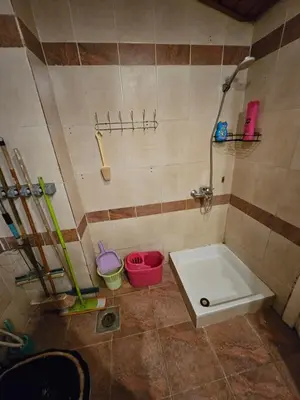 a bathroom with a tub and a shower with buckets at Desert Rose residence 1 bedroom flat in El Kawher in Hurghada