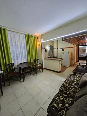 a living room with a couch and a table at Desert Rose residence 1 bedroom flat in El Kawher in Hurghada