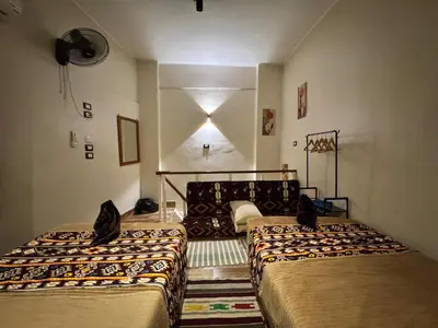 a bedroom with two beds in a room at Grand Duplex in Aswan