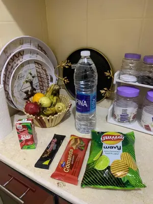 a counter with some food and a bottle of water at Pharaoh apatrtment in Al Karnak