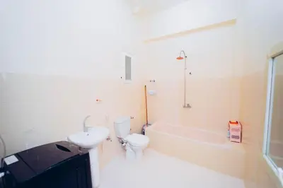 a bathroom with a toilet and a tub and a sink at Pharaoh apatrtment in Al Karnak