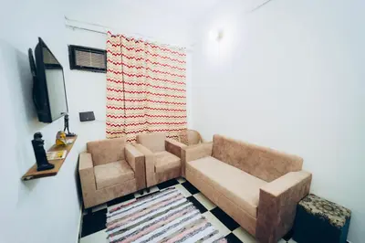 a living room with a couch and a television at Pharaoh apatrtment in Al Karnak