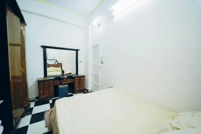 a bedroom with a bed and a mirror and a dresser at Pharaoh apatrtment in Al Karnak