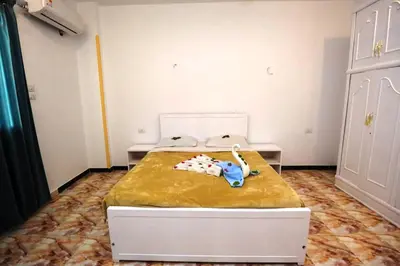 a bedroom with a bed with an elephant toy on it at Luxor View Hotel in Luxor