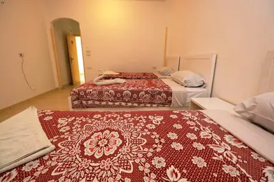 two beds in a hotel room with at Luxor View Hotel in Luxor