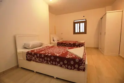 a small room with two beds and a window at Luxor View Hotel in Luxor