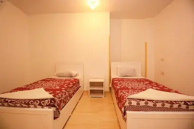 a bedroom with two beds and a small table at Luxor View Hotel in Luxor
