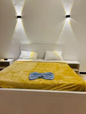 a bedroom with a bed with a bow tie on it at Luxor View Hotel in Luxor