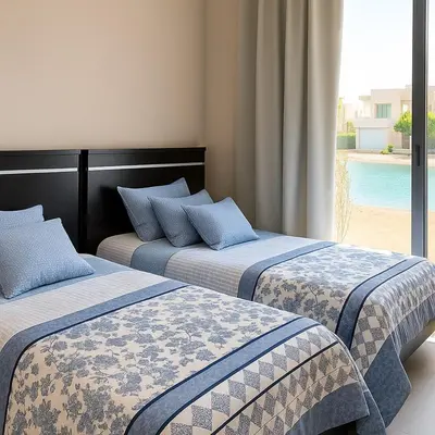 two beds sitting next to each other in a room at lagoon villa in Hurghada