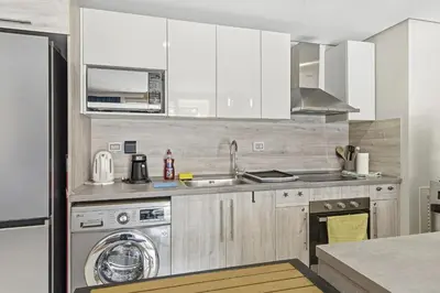 a kitchen with a sink and a washing machine at Luxurious private Getaway in Mangroovy in Hurghada