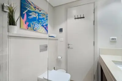 a white bathroom with a toilet and a sink at Luxurious private Getaway in Mangroovy in Hurghada