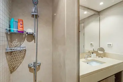 a bathroom with a shower with a sink and a mirror at Luxurious private Getaway in Mangroovy in Hurghada