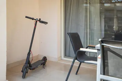 a scooter in a room with a chair and a window at Luxurious private Getaway in Mangroovy in Hurghada