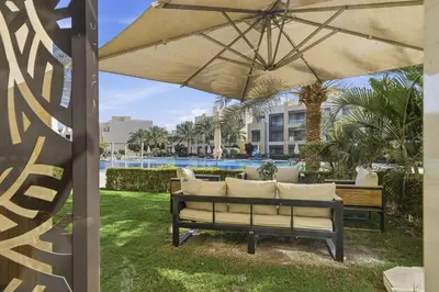 a patio with a couch and an umbrella at Luxurious private Getaway in Mangroovy in Hurghada