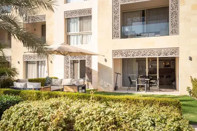 a building with a patio with a table and chairs at Luxurious private Getaway in Mangroovy in Hurghada