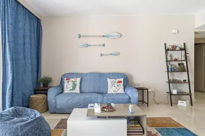 a living room with a blue couch and a table at Luxurious private Getaway in Mangroovy in Hurghada
