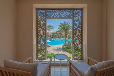 an open window with a view of a pool at Elegant 2BR Plus Nanny Room in Mangroovy Gouna in Hurghada