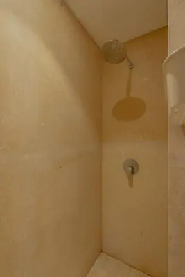 a shower with a shower head in a bathroom at Elegant 2BR Plus Nanny Room in Mangroovy Gouna in Hurghada