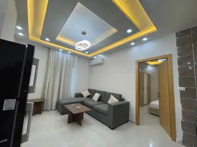 a living room with a couch and a tv at Elamer building in Hurghada