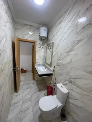a bathroom with a toilet and a sink at Elamer building in Hurghada