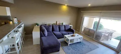 a living room with a purple couch and a table at Joubal lagoon Elgouna 2BD in Hurghada