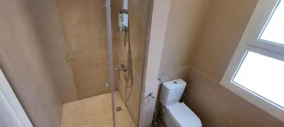 a bathroom with a glass shower with a toilet at Joubal lagoon Elgouna 2BD in Hurghada