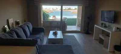 a living room with a couch and a table at Joubal lagoon Elgouna 2BD in Hurghada