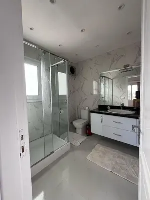 a bathroom with a shower and a sink and a toilet at white villa 4 bedroom elgouna heated pool in Hurghada