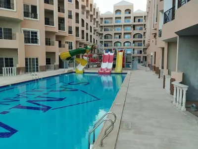 a pool at a apartment complex with a playground at Luxurious and Cozy Seafront Studio Near Gouna in Hurghada