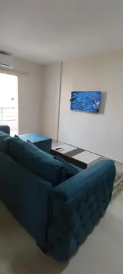 a living room with a blue couch and a table at Zahabia Golden Beach Resort Down Town in Hurghada