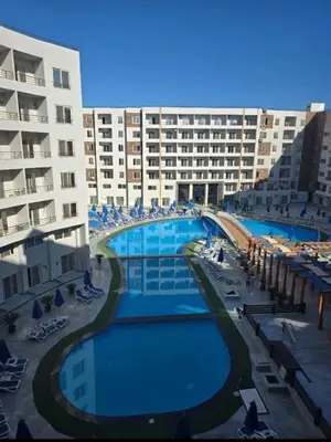 a view of a hotel with a large swimming pool at Zahabia Golden Beach Resort Down Town in Hurghada