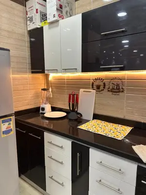 a kitchen with a black counter top with a plate at Tulip residence villa 1 in Hurghada