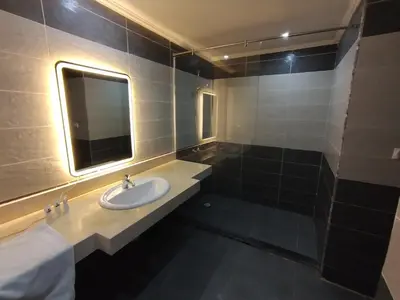 a bathroom with a sink and a mirror at Cozy Studio in modern resort in Hurghada