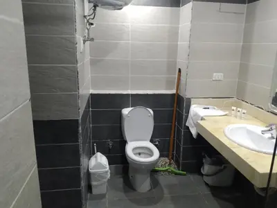 a bathroom with a toilet and a sink at Cozy Studio in modern resort in Hurghada