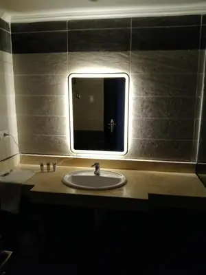 a bathroom with a sink and a mirror at Cozy Studio in modern resort in Hurghada