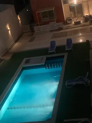 a swimming pool in a house with a blue light at for peivate and calm near gouna in Hurghada