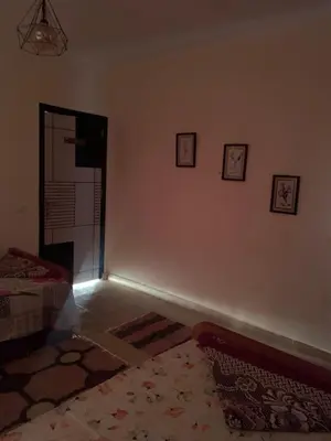 a living room with a bed and a mirror on the wall at for peivate and calm near gouna in Hurghada