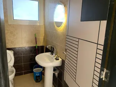a bathroom with a sink and a toilet and a window at for peivate and calm near gouna in Hurghada