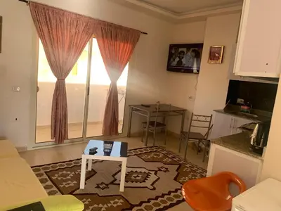 a living room with a couch and a table and a window at for peivate and calm near gouna in Hurghada