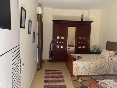 a bedroom with a bed and a door leading into a room at for peivate and calm near gouna in Hurghada