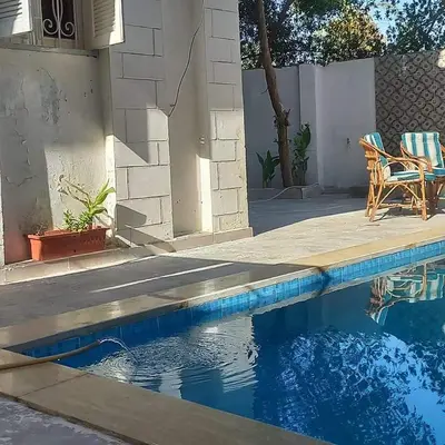 a house with a swimming pool and a patio at Villa Rose - Luxor in Luxor
