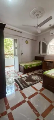 a room with two beds in a room with a floor at Villa Rose - Luxor in Luxor