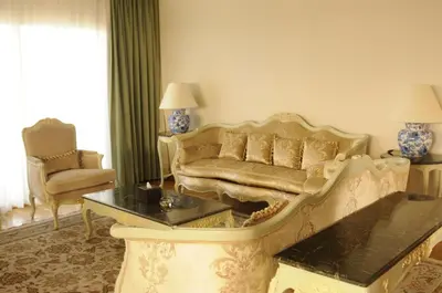 a living room with a couch and a table at HRG Best Hotel in Hurghada